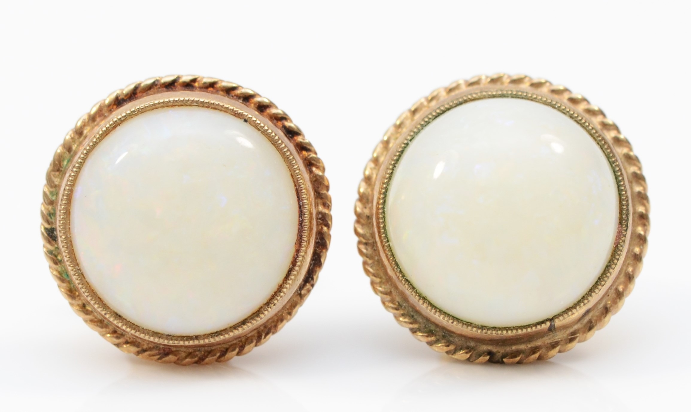 A pair of 9ct gold opal stud earrings, flashes of red, green and blue, 12mm, 3.9gm.