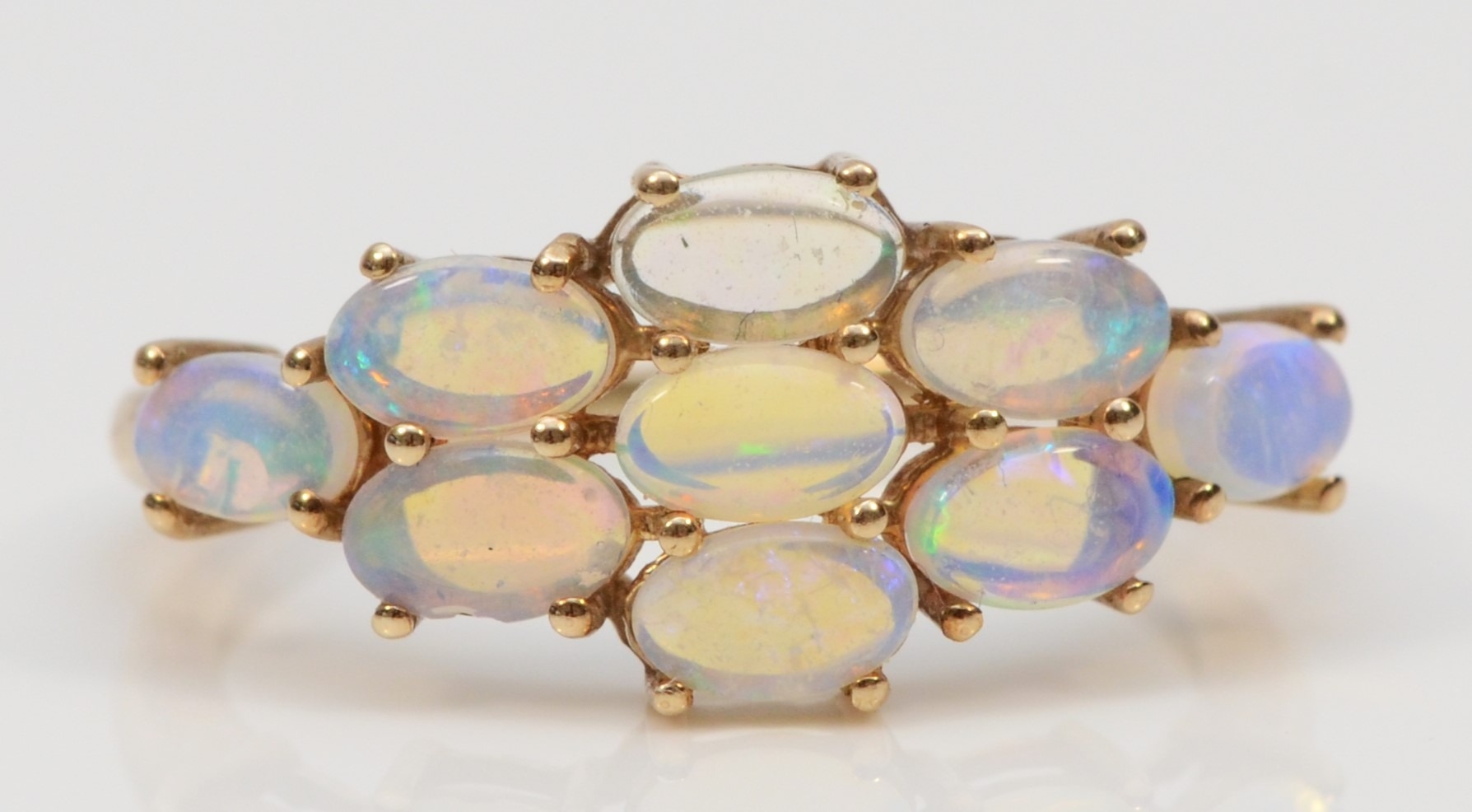 A 9ct gold crystal opal cluster ring, flashes of green, blue and yellow, O, 1.8gm.