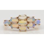 A 9ct gold crystal opal cluster ring, flashes of green, blue and yellow, O, 1.8gm.