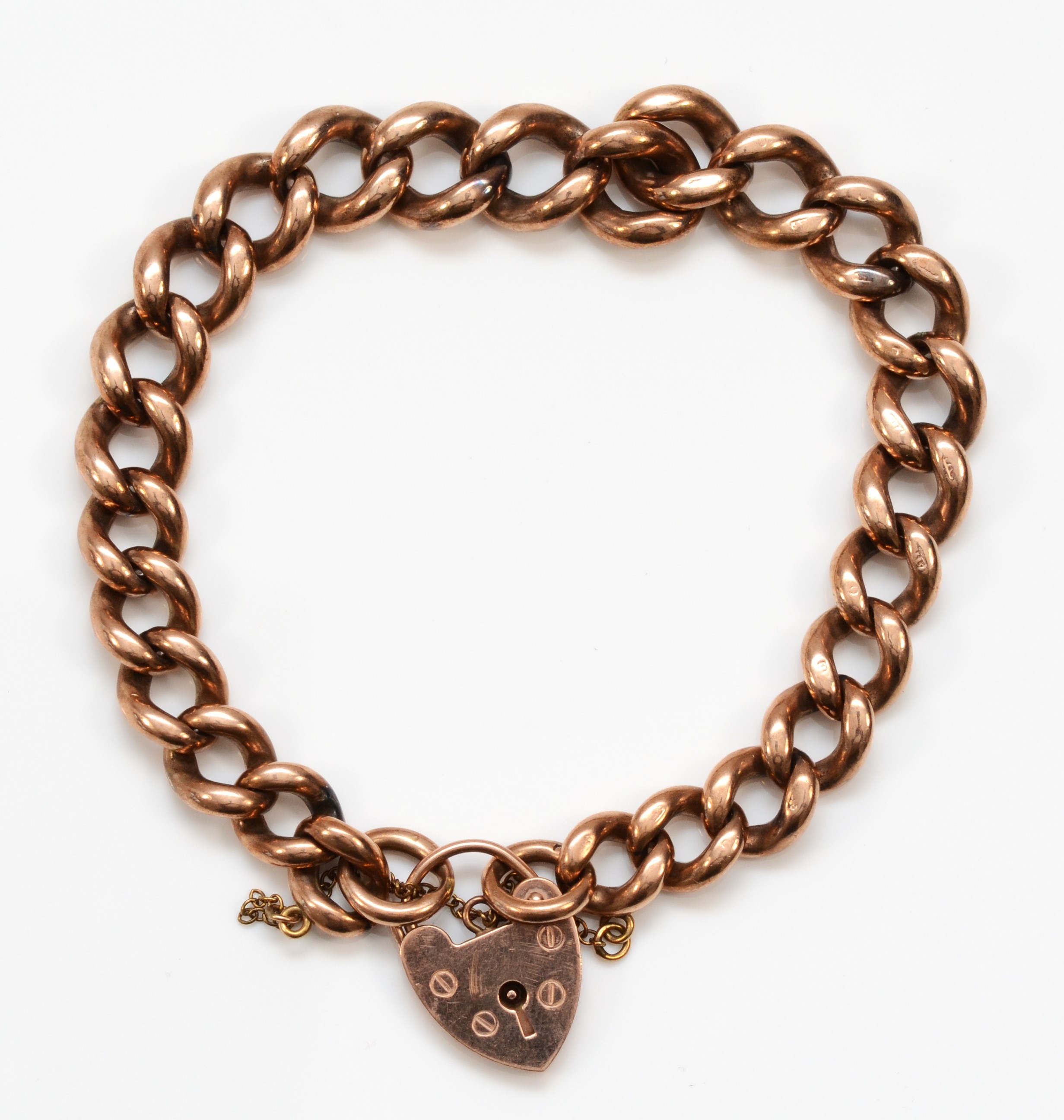 A 9ct rose gold curb link heart padlock clasped bracelet, 47gm.