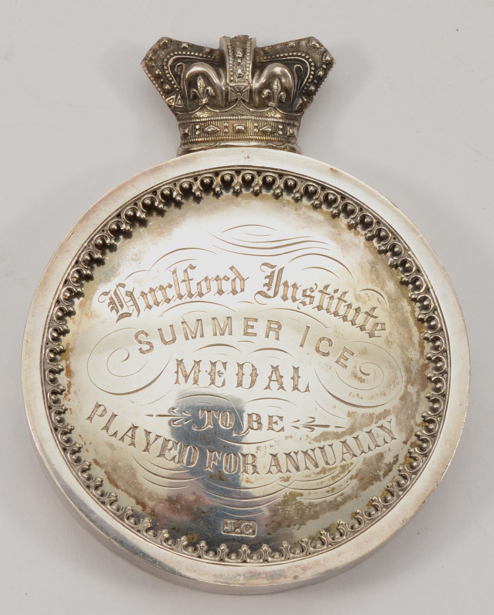 A Victorian silver presentation medal, by J.C, c.1897, of circular form with Victorian crown