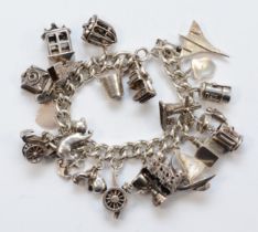 A silver charm bracelet with charms, lacking clasp, to include a Concord plane example, 131gm.