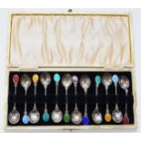 A set of twelve early 20th century continental silver and enamel tea spoons, cased, 60gm.