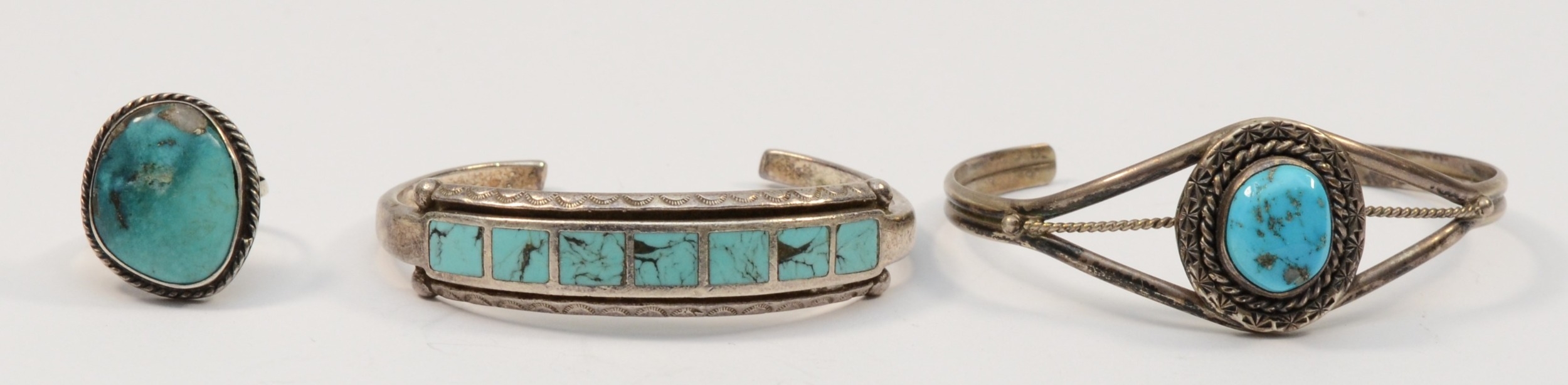 Two silver native American turquoise bracelets, unmarked, and a silver turquoise free form ring,