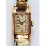 Rolco, A 9ct gold cased rectangular Ladies wrist watch, the silvered dial set with Arabic