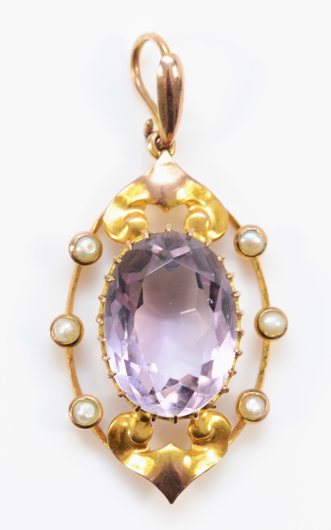 An Edwardian gold amethyst and seed pearl openwork pendant, unmarked, 35mm, 2.8gm.