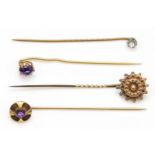 A Victorian gold sun burst stick pin , unmarked, 6.5cm, together with two gold amethyst stick