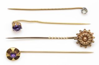 A Victorian gold sun burst stick pin , unmarked, 6.5cm, together with two gold amethyst stick