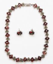 A silver garnet and marcasite necklace, with matching earrings, 42cm, 65gm.