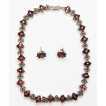 A silver garnet and marcasite necklace, with matching earrings, 42cm, 65gm.