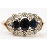 A 9ct gold three stone sapphire and eight cut diamond dress ring, S, 2.2gm.