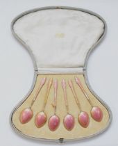 A set of Art Deco silver gilt and pink gouache enamel tea spoons, London import 1920, 65gm, cased.