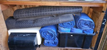 A Sunlight roller towel dispenser, various towlel rolls and three workshop mats