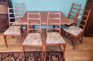 A mid 20th century teak dining suite, comprising dining table with built in leaf, 122x85cm, together