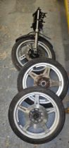 A Honda Superdream front wheel and forks, and a pair of Honda front and rear wheels