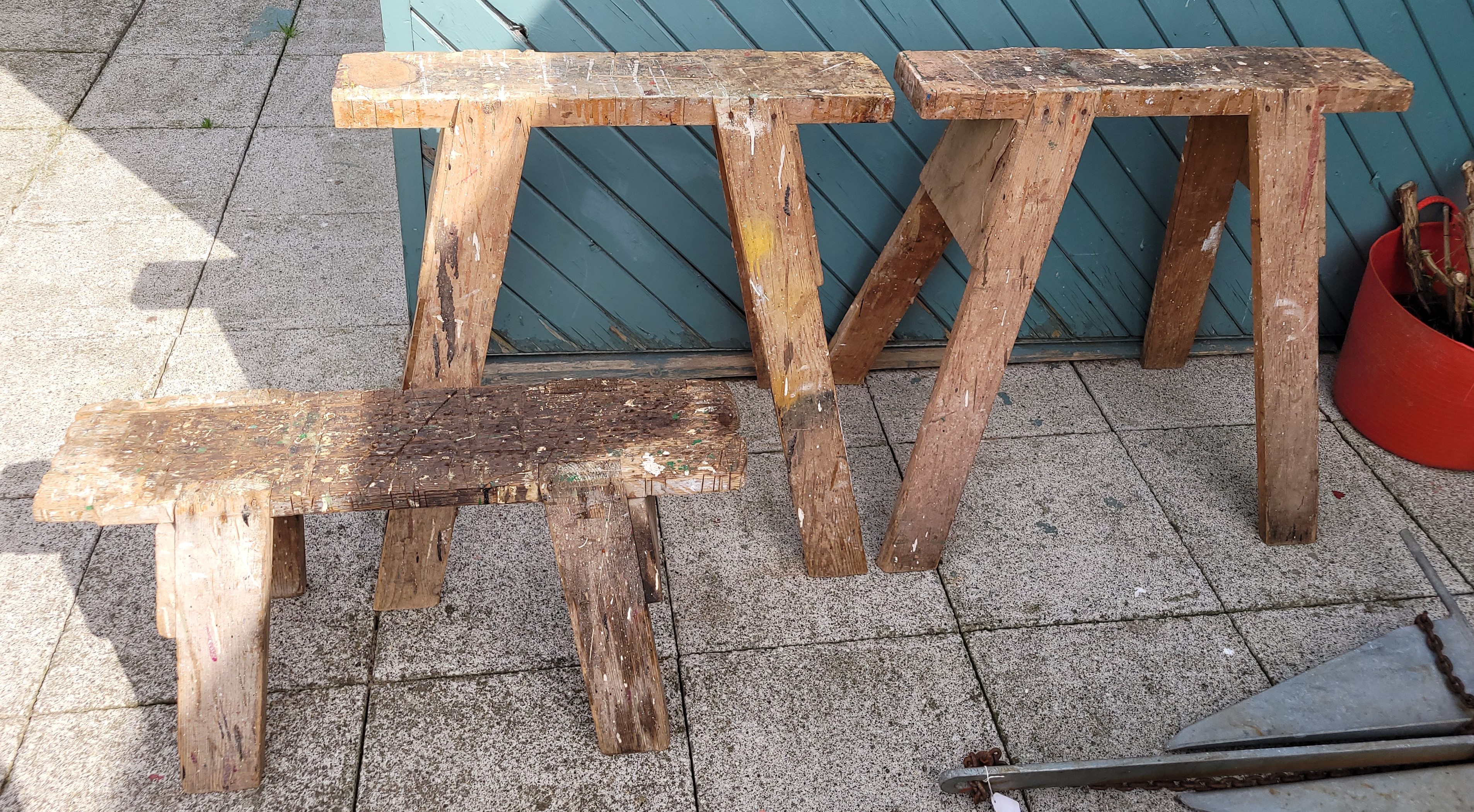 A pair of vintage industrial work sawhorses/trestales, H80, W75cm, together with a smaller example.