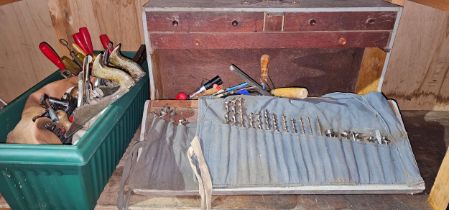 A woodeworkers tool box with various workworking tools and drills