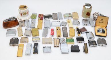 A collection of mid 20th century and later cigarette lighters, pocket and table, gas and petrol