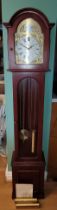 A contemporary German mahogany effect triple weight Grandmother clock, with Westminster chimes,