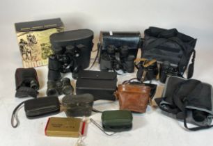 A collection of twelve pairs of cased binoculars.
