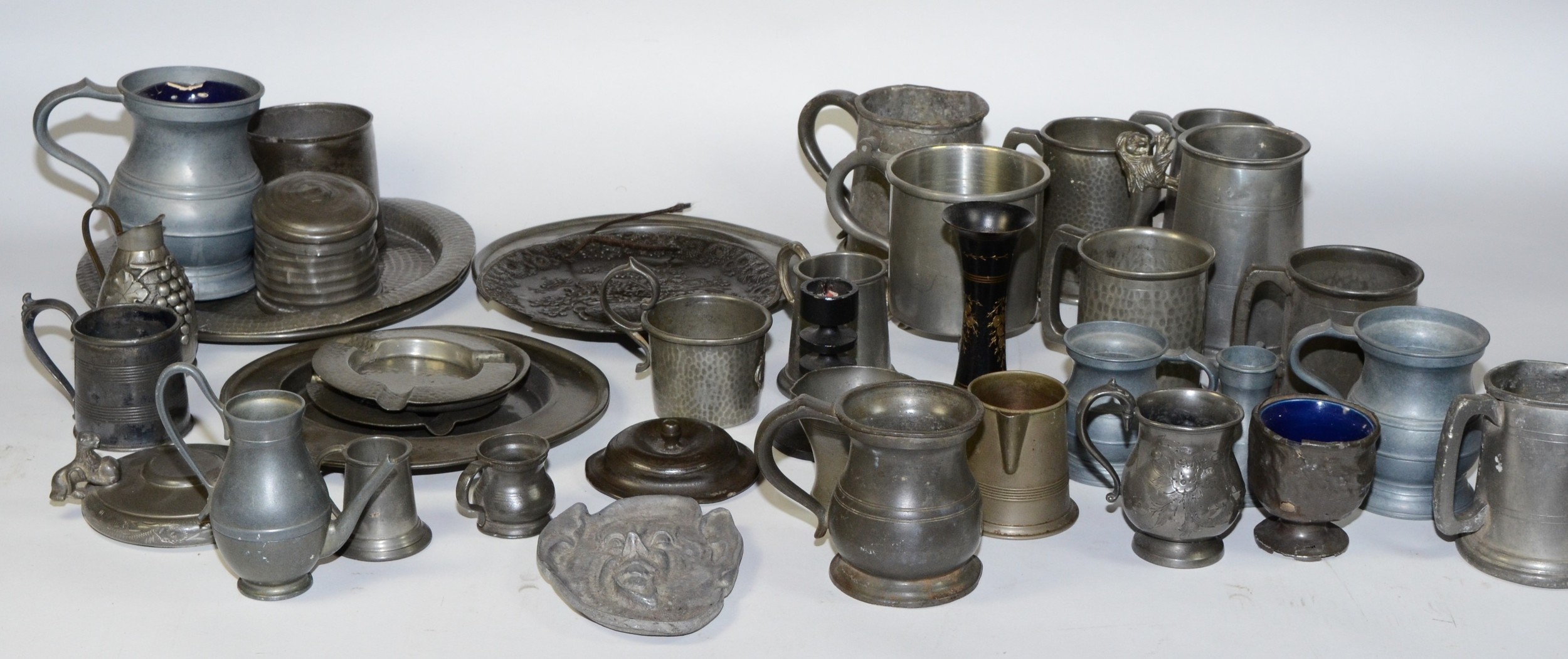 A collection of early 20th century and later pewter wares, to include plates, tankards and jugs.