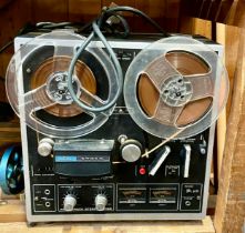 An Akai 1721L four track reel to reel player.