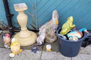 A collection of garden figural ornaments, together with a concrete pedestal.