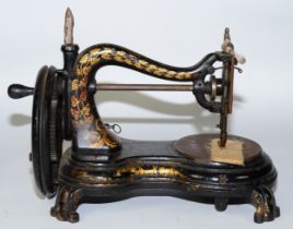 A late 19th century Jones portable hand sewing machine, black painted cast metal having gold vine