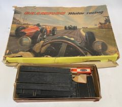 A 1960s Playcraft motor racing game, boxed with spare track and accessories.