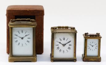 A 20th century English brass carriage clock, having 8 day movement, with travel case, 11cm tall,