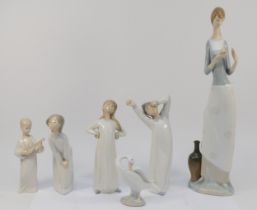 A collection of Lladro porcelain figures, comprising of a lady stood reading a book, 40cm tall,