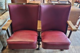 A pair of mid 20th century cast iron cinema/theatre stall seats, the fold up seats upholstered in