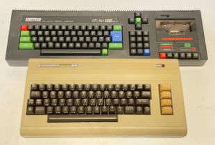 A Commodore C64 computer, together with a Amstrad CPC 464 computer. (2)