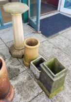 A stone effect sundial column, 93cm tall, together with two chimney pots and a planter.