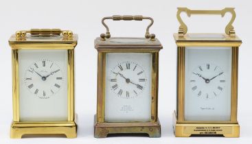 Three mid 20th century brass carriage clocks, having enamelled dials with 8 day movements. (3)