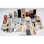 A collection of mid 20th century and later cigarette lighters, pocket and table, gas and petrol