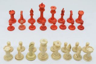 An early 20th century barleycorn carved and turned bone chess set, with red stained and plain