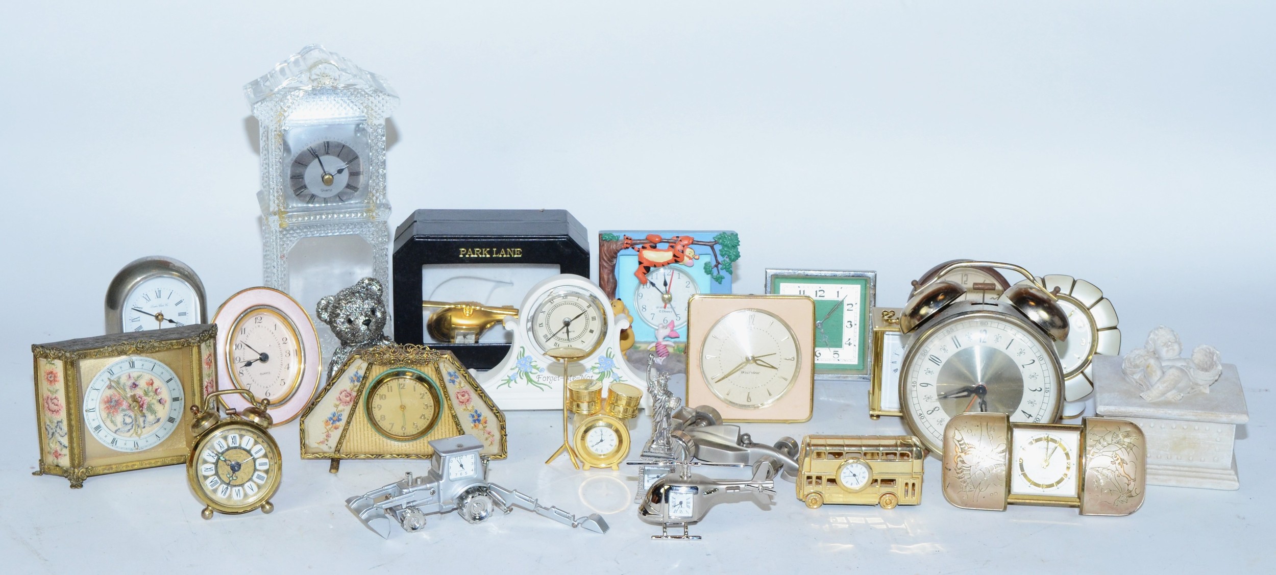A collection of miniature novelty clocks, together with traveling alarm clocks, having manual and