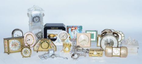 A collection of miniature novelty clocks, together with traveling alarm clocks, having manual and