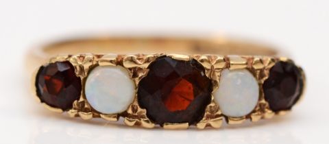 A 9ct gold opal and garnet five stone ring, carved setting, K, 2.3gm