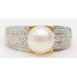 A 14ct gold and 8mm cultured pearl dress ring, the shoulders set with two diamonds, N, 3.5gm