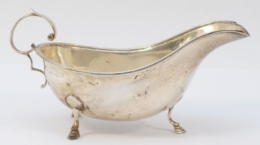A silver gravy boat, marks worn, probably Birmingham 1932, with reeded border, 18.5cm, 138gm