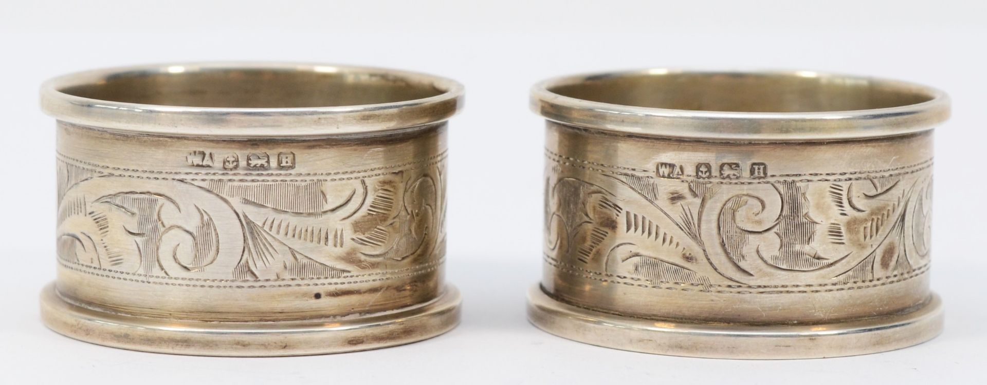 A pair of silver napkin rings, Birmingham 1932, both with E.M.B. initials and a metal Kings and - Image 2 of 3