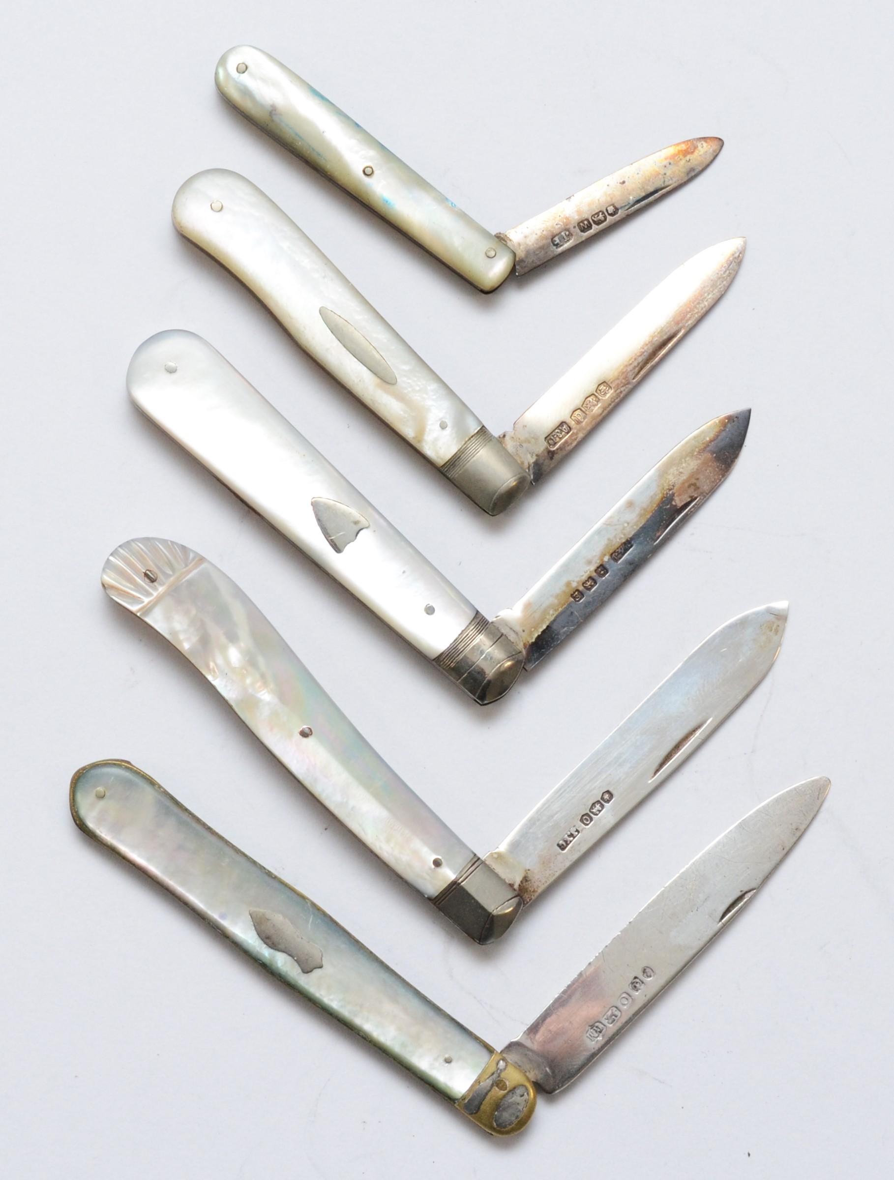 A Victorian silver and mother of pearl fruit knife, Sheffield 1881 and four other later examples.