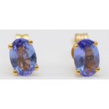 A 14k gold and tanzanite pair of ear studs, 9ct butterflies, 0.6gm