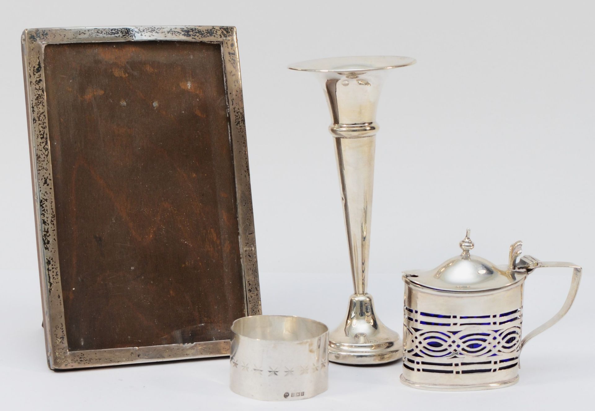 A Victorian silver mustard pot, Chester 1898, with blue glass liner, a silver specimen vase, loaded,