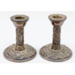A pair of silver candlesticks, Birmingham 1973, with bird and scroll embossed decoration, 10cm,