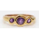 A 9ct gold three stone amethyst ring, Q, 2gm