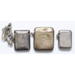 Three silver vesta cases, Birmingham 1906, 1912 and Sheffield 1899, with metal chain attached,