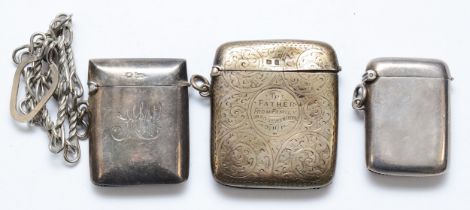 Three silver vesta cases, Birmingham 1906, 1912 and Sheffield 1899, with metal chain attached,